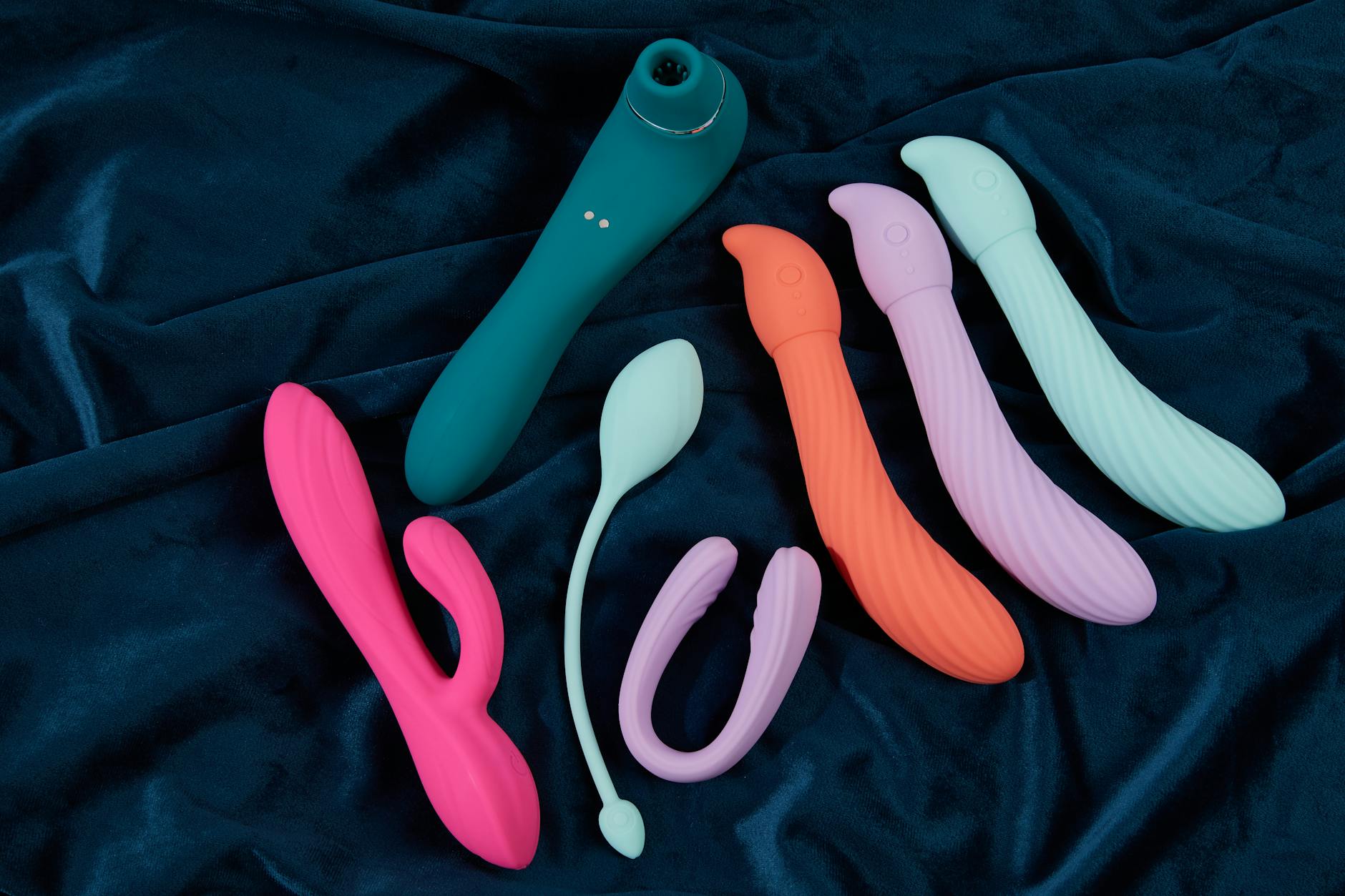 A yellow silicone vibrator surrounded by peeled bananas on a bright yellow background, representing refreshed pleasure