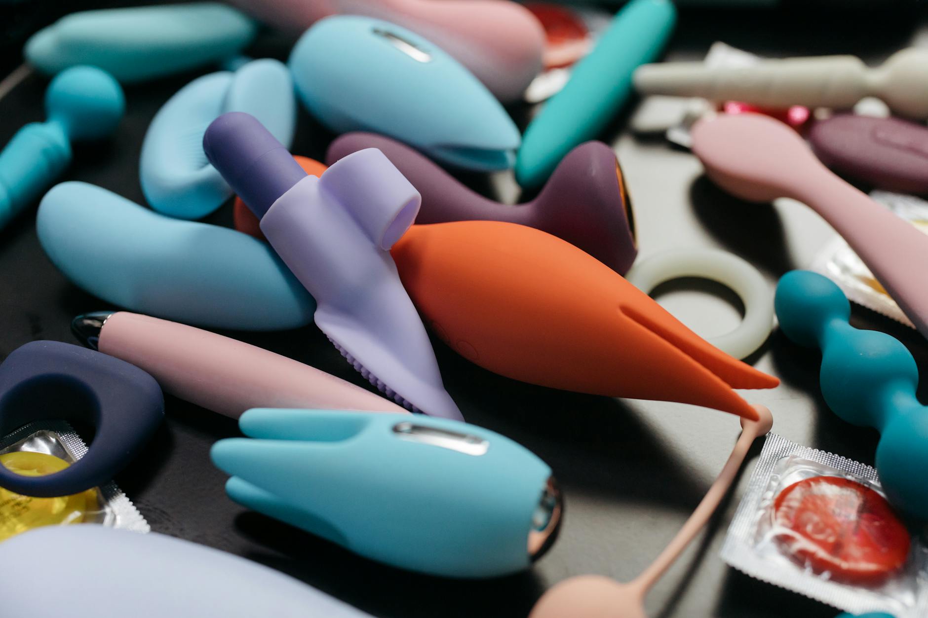 An array of vibrant clitoral vibrators in a close-up view.