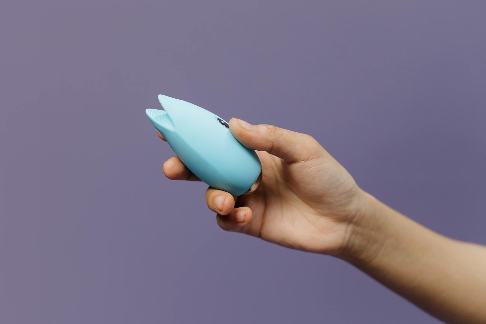 A yellow silicone vibrator with fresh lemons on a bright background, symbolizing playful couple reconnection
