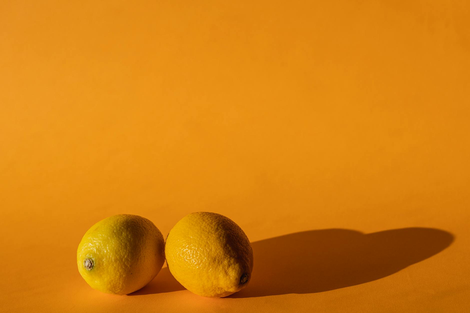 Two women smiling with lemons, expressing joy and self-care moments